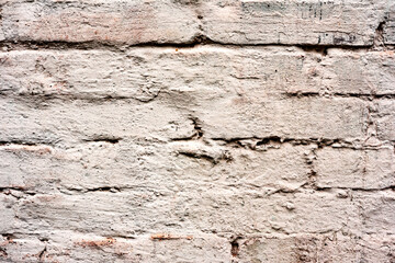 Texture of a brick wall with cracks and scratches which can be used as a background