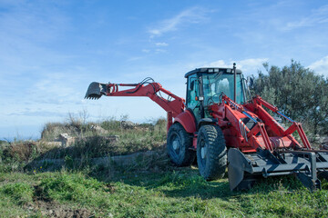 Tractor with backhoe in action