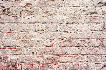 Texture of a brick wall with cracks and scratches which can be used as a background