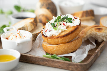 toasted buns with curd cheese and fresh herbs