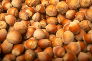 Hazelnuts in bulk. Surface texture. Close up.