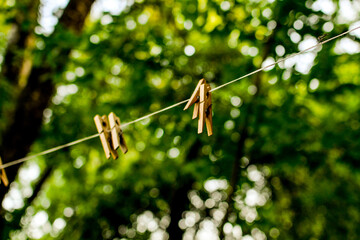 wooden clothespins hanging on a clothesline outside