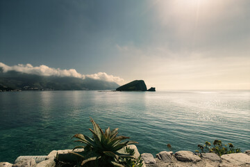 Early morning seascape. Sunlit path over Adriatic sea. Sun glare on the surface of the sea. Agava...