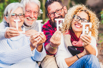 Group of mixed ages people celebrate life with blocks and smiles - people family of friends...