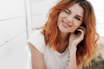 Portrait of a young smiling happy ginger woman outdoor