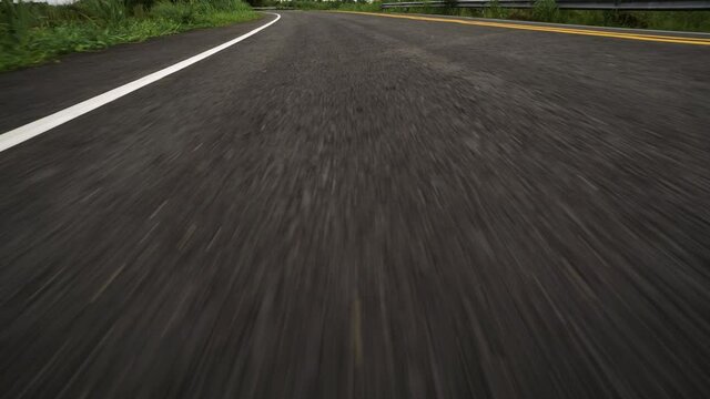 Front pov view of fast car driving on asphalt road

