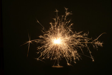 New Year Christmas sparkler on dark background with bokeh lights