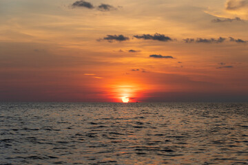 Sunset on the island of Phu Quoc, Vietnam. Travel and nature concept. Evening sky, clouds, sun and sea water
