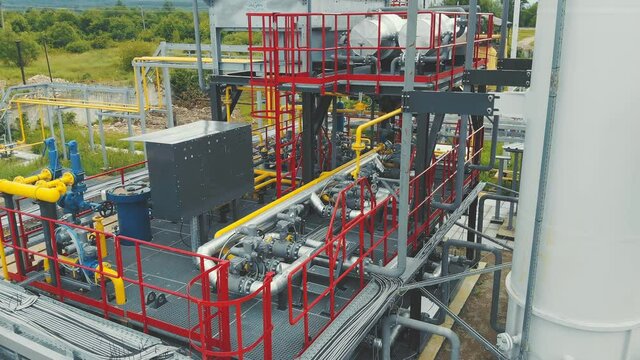 Aerial view Gas production station. Metal construction with valves on the pipes. Distribution and equipment for gas production.