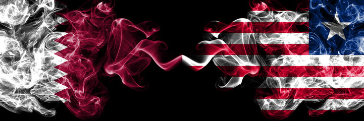 Qatar vs Liberia, Liberian smoky mystic flags placed side by side. Thick colored silky abstract smoke flags.