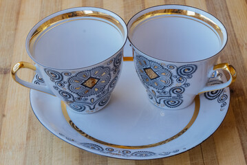 striking Chinese porcelain Cup with saucer on a wooden background