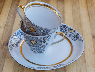 striking Chinese porcelain Cup with saucer on a wooden background