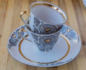 striking Chinese porcelain Cup with saucer on a wooden background