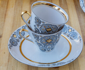 striking Chinese porcelain Cup with saucer on a wooden background