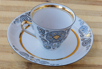 striking Chinese porcelain Cup with saucer on a wooden background