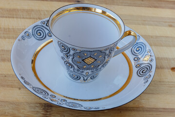 striking Chinese porcelain Cup with saucer on a wooden background