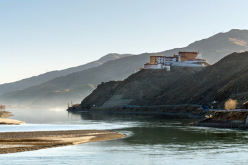 Tibetan Buddhist monastery on a hill near a winding river, Tibet