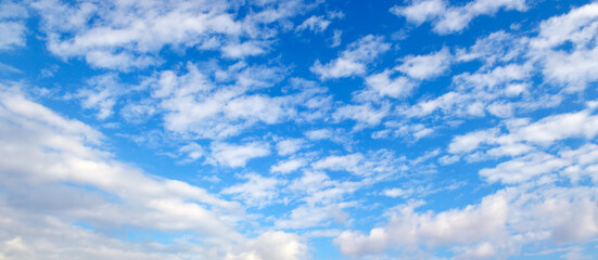 Blue sky background with clouds. Wide photo