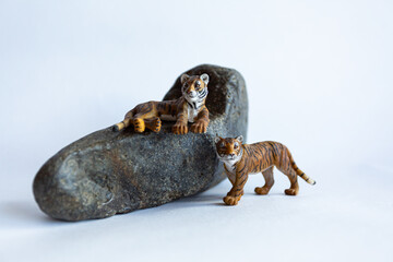 Obraz premium Toy tiger cubs on a white background