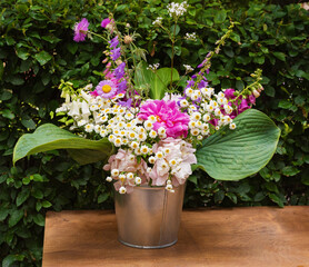 summer bouquet of blooming peonies and wildflowers