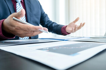 Hand of businessmen are planning business investments related to shares By analyzing and calculating the stock market for marketing profits