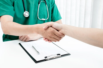 Male doctors and patients shook hands after the patients had finished their treatment. Medical concepts and good health