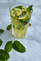 Refreshing drinks for summer, cold sweet and sour lemonade juice in the glasses with sliced fresh lemons. Refreshing summer drink. Traditional lemonade with lemon and mint. Selective focus