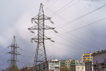 Gloomy blue dark storm sky over esidential buildings in Moscow in spring. Modern buildings. Voltage towers, tops of trees nearby. Concepts of lifestyle in the big city. Telephoto lens