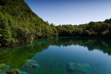 The emerald waters of Lake Cornino in the Cornino regional nature reserve, Italy