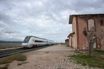 train passing an old train station