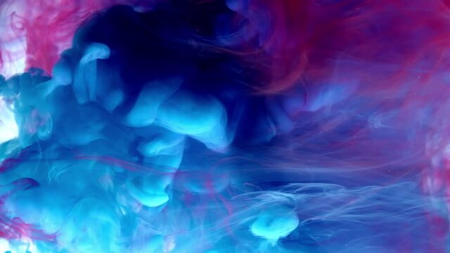 Blue and red mixing in water on white background, Slow motion.