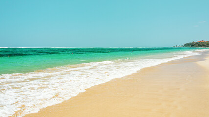 Fototapeta na wymiar beautiful sandy beach in waves on the ocean coast. Concept of recreation in tropical countries