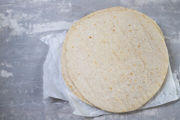 tortilla on white paper on ceramic background
