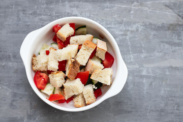 cold tomato soup gaspacho with bread in white bowl