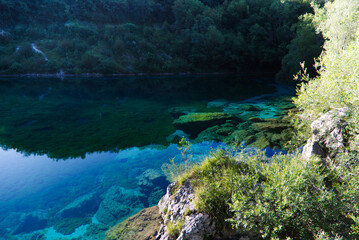 The emerald waters of Lake Cornino in the Cornino regional nature reserve, Italy