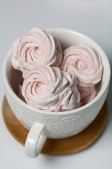 Homemade zephyr in a mug. On the white surface.