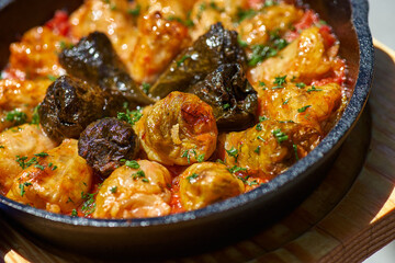 Homemade cabbage rolls stuffed with meat and rice in a cast iron pan, selective focus