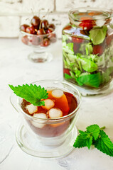 glass Cup and a large jug of icy summer mint tea. concept of coolness in the hot summer