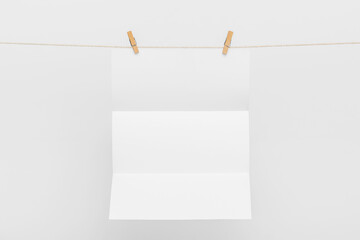 Blank Card Hanging on a Clothesline against White