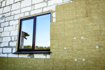 House thermal insulation mineral wool slabs. Inside wall heat isolation with mineral wool.