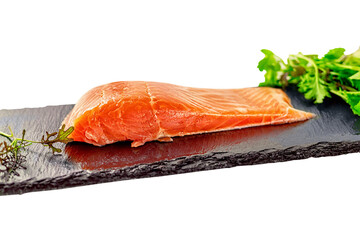 piece of smoked fresh salmon with lettuce leaves on a slate. isolated on white