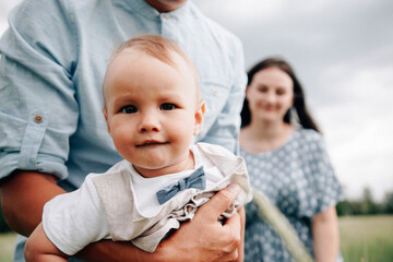 A happy family walks with a child in nature