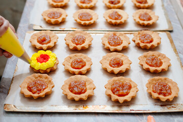 The process of making a tartlet cake. Tart cake. Cake basket. The process of filling cream cakes. Cream with food colors. Dye colored cream. Home kitchen. Homemade Tart Basket Cakes