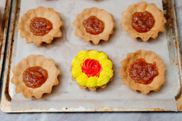 The process of making a tartlet cake. Tart cake. Cake basket. The process of filling cream cakes. Cream with food colors. Dye colored cream. Home kitchen. Homemade Tart Basket Cakes