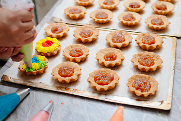 The process of making a tartlet cake. Tart cake. Cake basket. The process of filling cream cakes. Cream with food colors. Dye colored cream. Home kitchen. Homemade Tart Basket Cakes