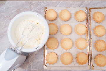 Butter cream for tart cakes. The process of making cream colored cream for tart tarts. Cream staining with food coloring. Whipping cream. Cream in pastry bags.