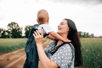 A happy family walks with a child in nature