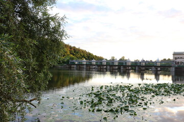 
Clouds are reflected in the water during sunset at the river dam