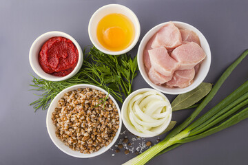 Step by step recipe. Cooking buckwheat cutlets or meatballs. Step 1 Ingredients: buckwheat, turkey meat, onion and egg. Homemade food concept. Сopy space for text