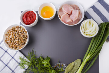 Step by step recipe. Cooking buckwheat cutlets or meatballs. Step 1 Ingredients: buckwheat, turkey meat, onion and egg. Homemade food concept. Сopy space for text